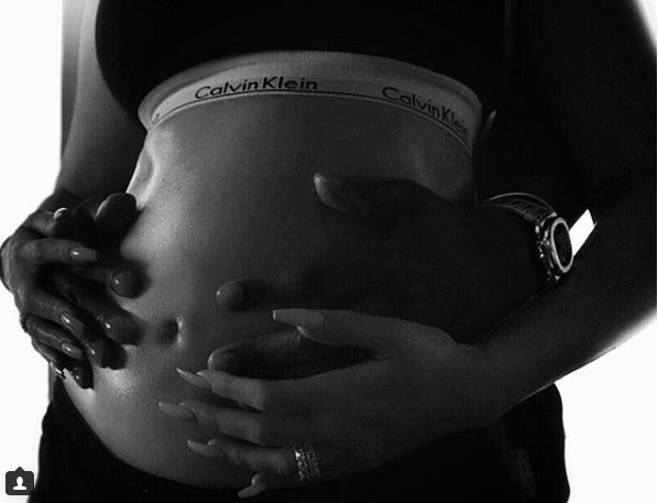 Khloe Kardashian and her boyfriend holding her baby bump
