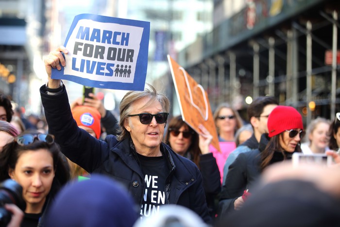 Paul McCartney holding a protest sign